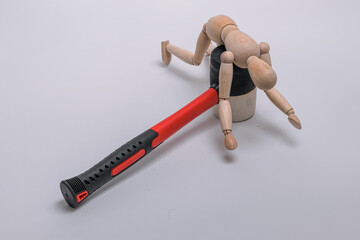 rubber mallet with a red handle and a wooden man hanging from it