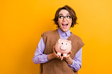 Photo of impressed girl dressed knitwear waistcoat in glasses hold piggy box look at sale empty...