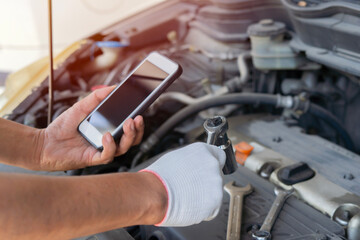 Mechanical fixing car at home. Repairing Service advice by mobile phone.