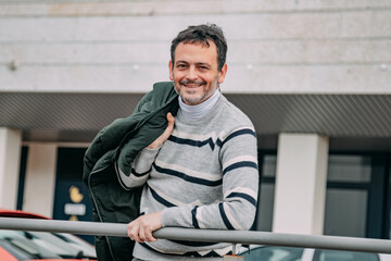 portrait of casual mature man smiling on the street