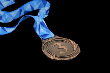 Bronze medal with ribbon isolated on black background	
