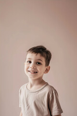 Portrait of a smiling boy on a beige background
