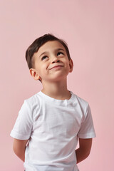 Portrait of a smiling boy on a pink background
