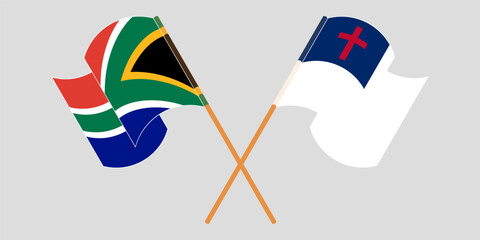 Crossed and waving flags of South Africa and christianity