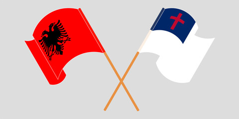 Crossed and waving flags of Albania and christianity