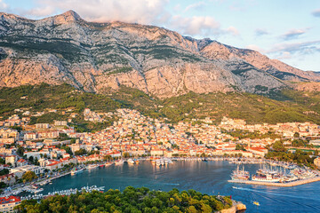 Aerial view of the harbor and old town of Makarska, Dalmatia, Croatia. Summer landscape with yachts, sea, architecture and rocks, famous tourist destination at Adriatic seacoast, travel background - 781161961