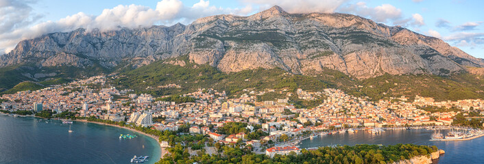 Aerial view of the town of Makarska, Dalmatia, Croatia. Summer landscape with yachts, sea, architecture and rocks, famous tourist destination at Adriatic seacoast, travel background, large panorama - obrazy, fototapety, plakaty