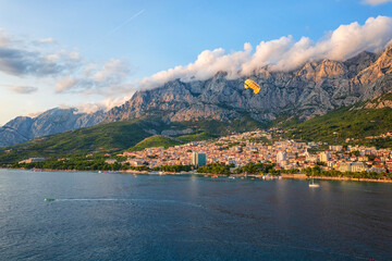 Beautiful aerial view of the town of Makarska, Dalmatia, Croatia. Summer landscape with yachts, sea, architecture and rocks, famous tourist destination at Adriatic seacoast, travel background - 781161982