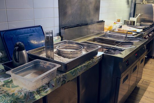 Equipment for deep-frying dishes. Industrial fryers in a restaurant. Stainless steel deep fryers close up