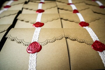 Closeup shot of decorative brown vintage envelopes with lace and a red stamp