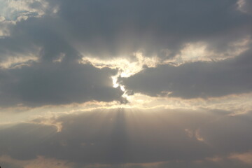 Morning sunrays with sun and clouds
