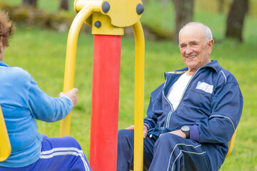 senior couple practicing exercise outdoors
