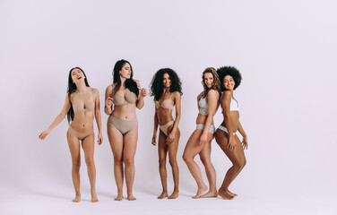 Group of women with different body and ethnicity posing together to show the woman power and strength. Curvy and skinny kind of female body concept - 781174505