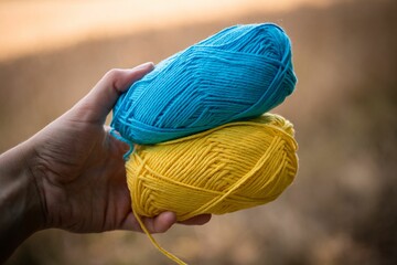 Closeup of blue and yellow threads in blurred background