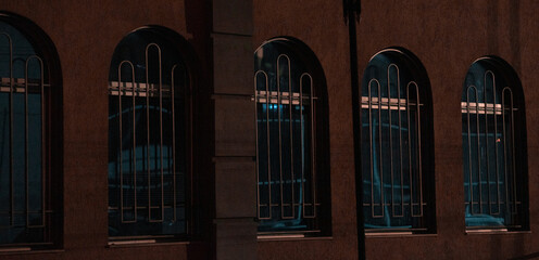 Windows of an old building at night.
