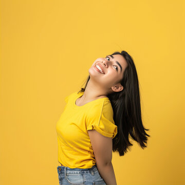 Portrait of a beautiful girl smiling on a yellow background
