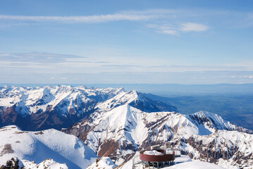 Breathtaking panoramic view of Murren ski resort, Switzerland. Circular building on snowy peak...