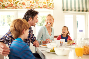 Family, food and parents with children for breakfast, eating and bonding together in dining room....