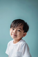 Little boy smiling on blue background
