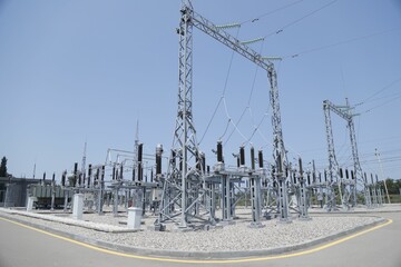 Aerial view of electrical substation surrounded by metal towers © Wirestock