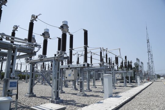 Aerial view of electrical substation surrounded by metal towers