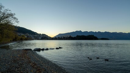 Scenic view of a beautiful dark lake landscape during sunset