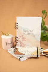 Vertical shot of a diary with Believe in yourself and everything will be possible text in Spanish