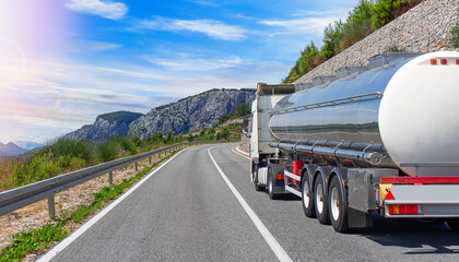 Fuel truck on a picturesque road. A white tank truck transports fuel.