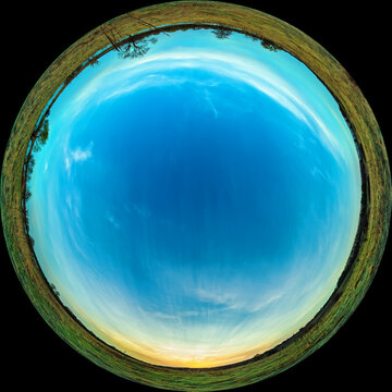 Sunset and sky over the meadow in the evening. Circular fisheye view of a spring landscape in the countryside. Panorama in fulldome photo format