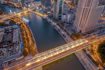 Aerial view of the Haihe River and the modern illuminated bridge in Tianjin China