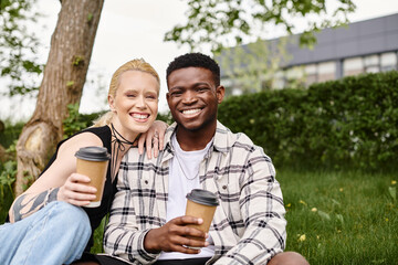 Multicultural couple, an African American man and a Caucasian woman, enjoying coffee together while...