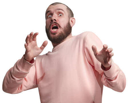 Man in pink sweatshirt being scared, expressing fear isolated on transparent background. Wide open eyes and gesturing. Being afraid of. Concept of human emotions, facial expression.