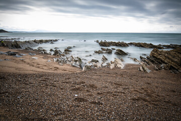 atlantic coastline in bidart, rocks and water in long exposure