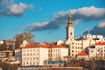 Discover Belgrade's architectural beauty, with churches and towers overlooking the scenic Danube River. - obrazy, fototapety, plakaty