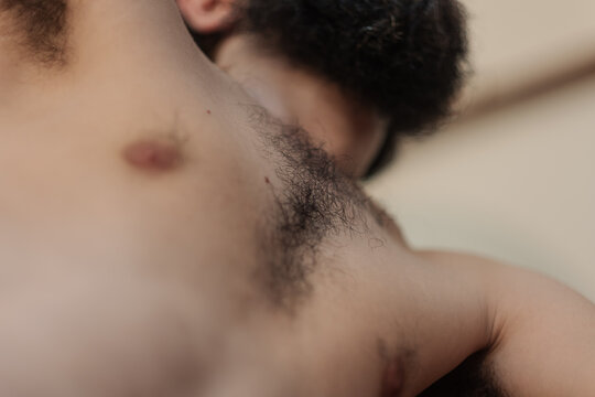 Self portrait of a man's upper body, showing his chest hair, underarm hair. The selective focus highlights his body hair but leaves his thick beard out of focus, adding a close and intimate feeling.