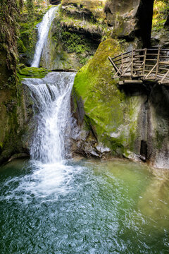 Dreamy waterfalls landscape at grotte del Caglieron, Fregona, Treviso province, Veneto, Italy. Water flowing and falling through mossy rocks.