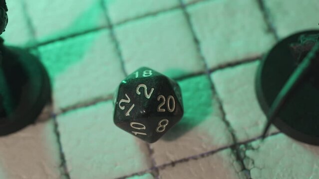 Rolling 20-sided or d20 dice to play tabletop game