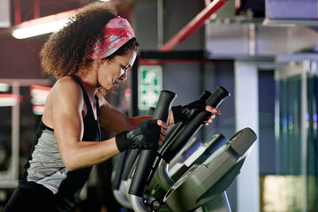 Fitness, gym or woman on stepping machine for a cardio workout and body training for endurance....