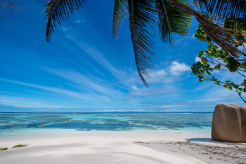 Tropical beach with bathers cooling off