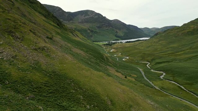 Drone scene over Cumbria highest passes The Honister Pass forms part of green valley