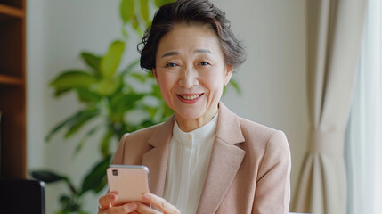 Senior businesswoman with smartphone, embracing technology.