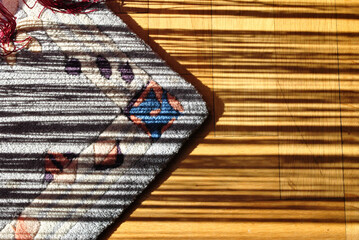 Abstract Shadows on Old Interior Wooden Floor with Colourful Rug 