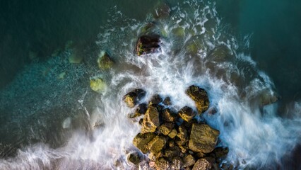 Aerial view of mossy rocks in the ocean