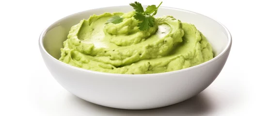 Foto auf Acrylglas Guacamole in a white dish with a touch of parsley © vxnaghiyev
