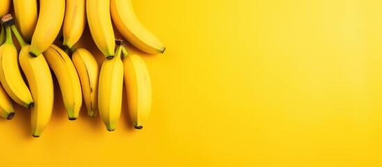 Bunch of bananas on vibrant yellow surface