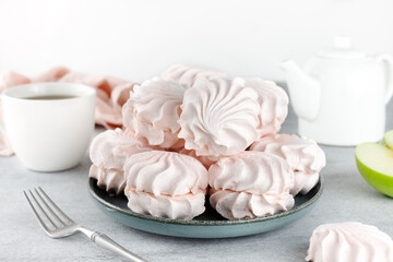 Russian sweet dessert - pink marshmallow zephyr on gray background. Meringue, souffle dessert. 