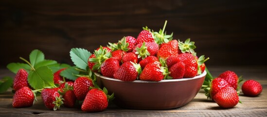 Bowl of strawberries on wooden surface - Powered by Adobe