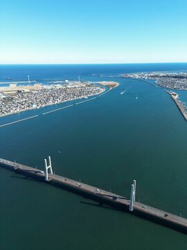 Aerial shot of the bridge over the sea with coastal Choushi city in the background