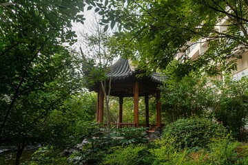 Wooden pavilion in a green park in china