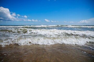Sea waves washing the sandy shore